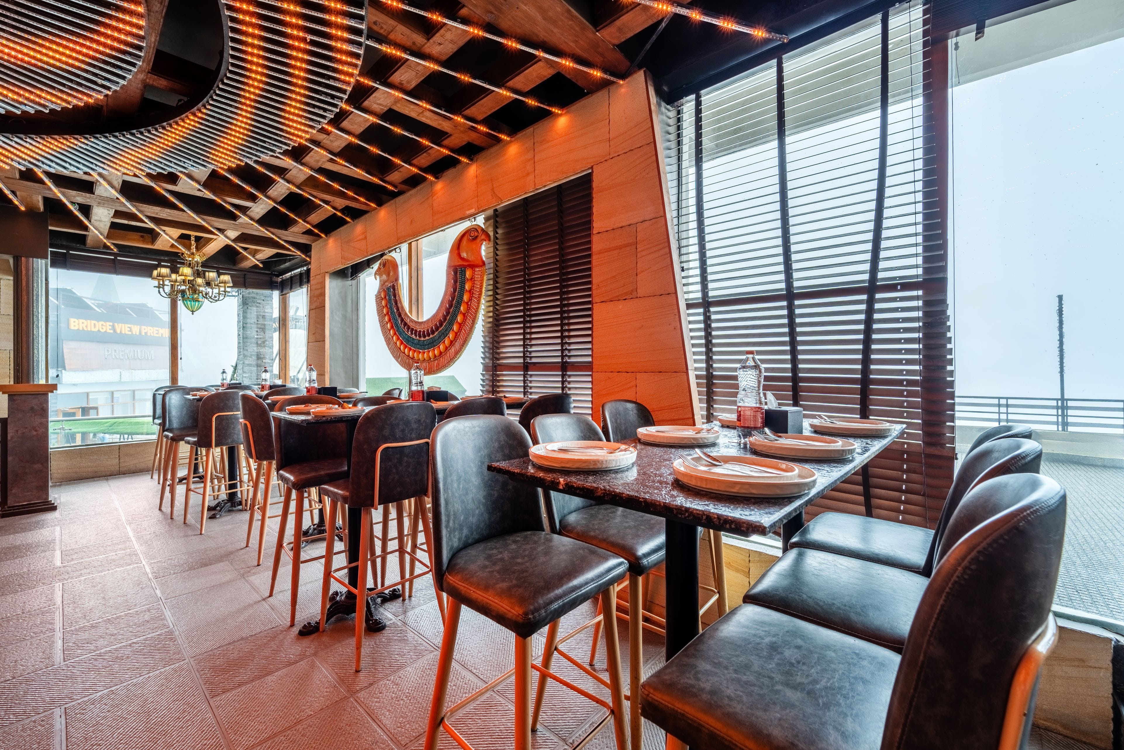 The Restaurant of Treebo Bridge View Regency, Mall Road in undefined. Tables set for comfortable dining